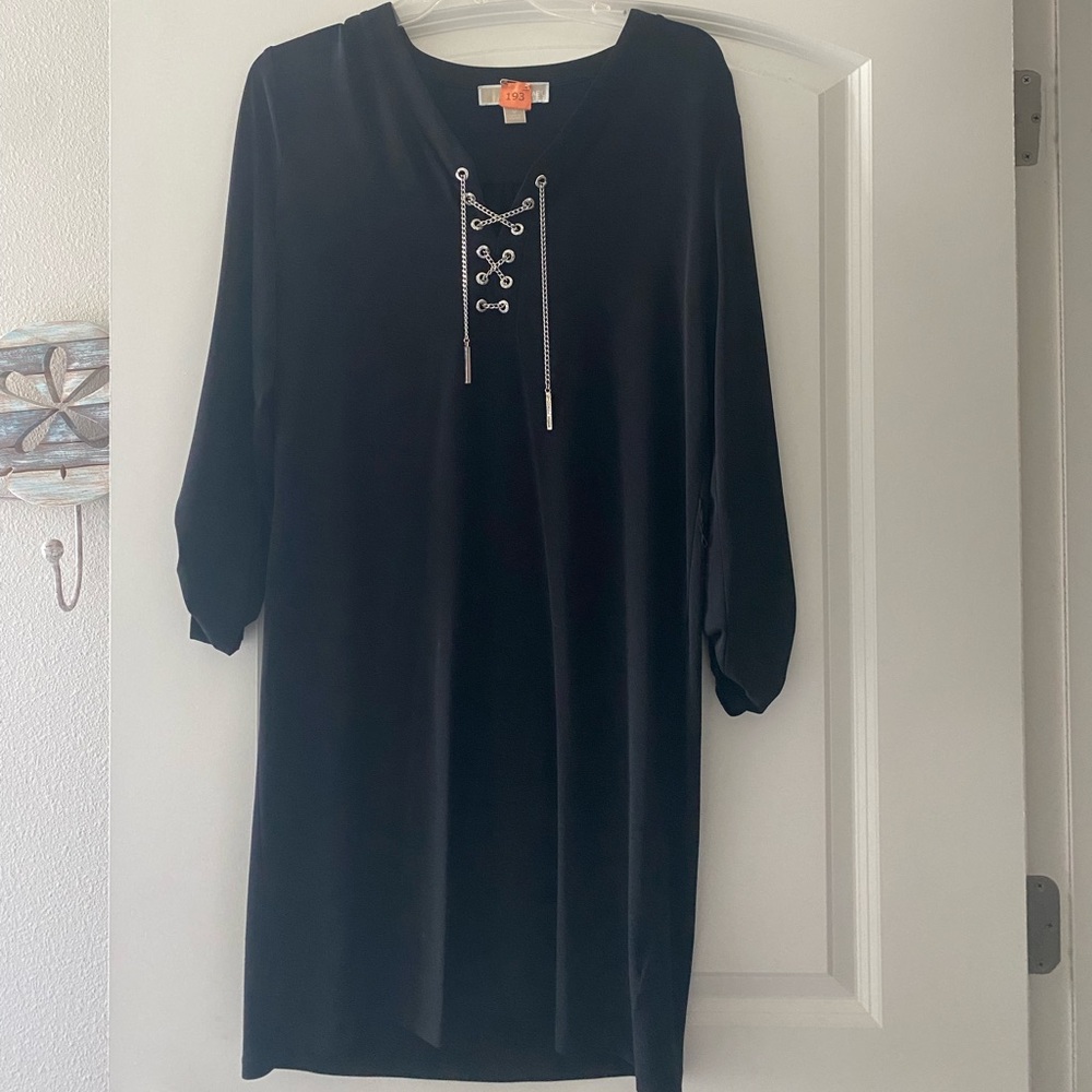 Black dress, with tie at waist. To knee.